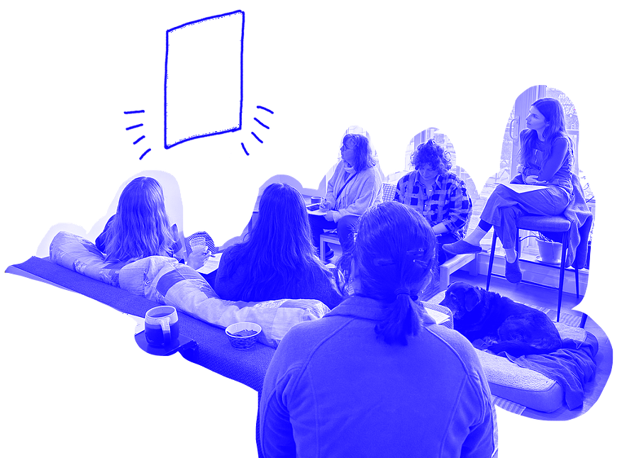 A group of people looking at artwork and doing crit.